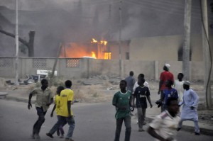 Smoke rises from the police headquarters as people run for safety in Nigeria's northern city of Kano Smoke rises from the police headquarters as people run for safety in Nigeria's northern city of Kano